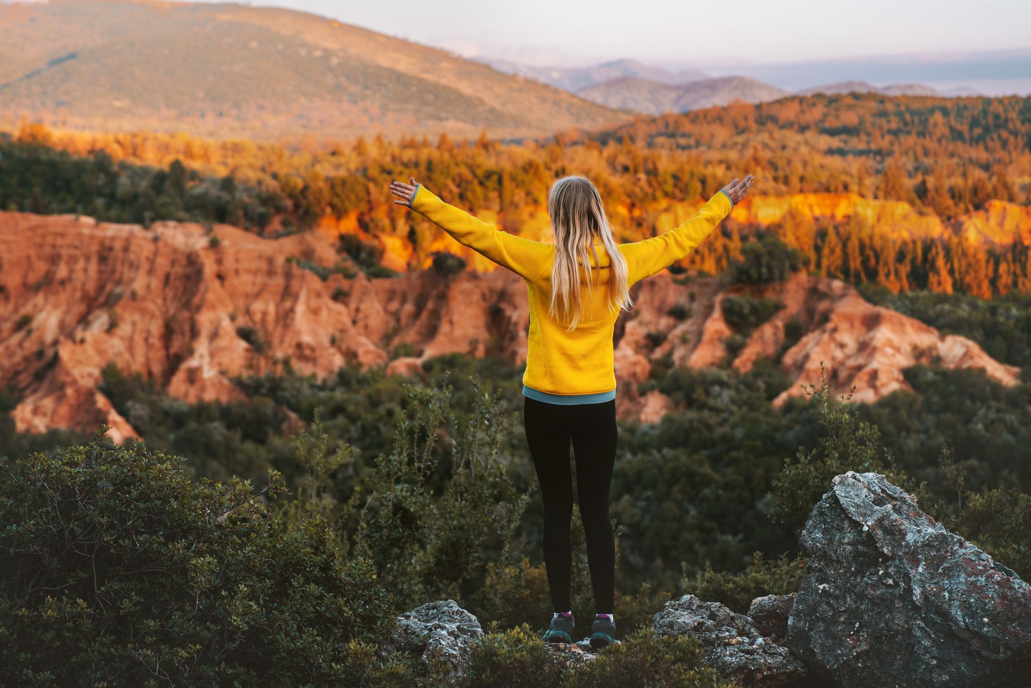 Photo of woman hiking outdoor raised hands enjoying Gjipe canyon in Albania.