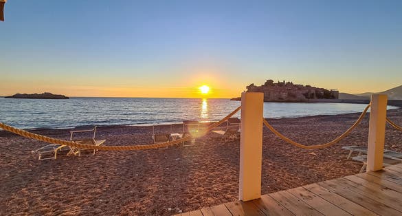 Photo of scenic sunset view from beach bar in Sveti Stefan, Montenegro.