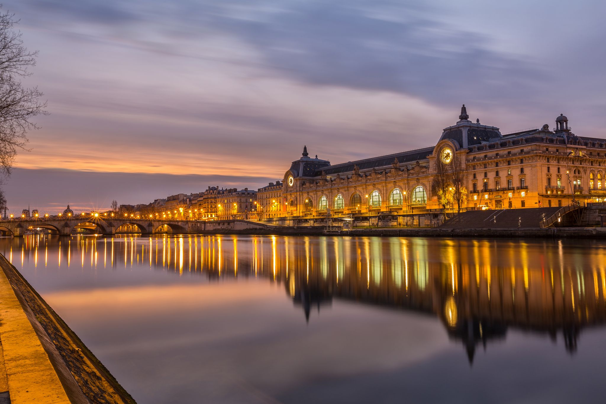 Photo of night view of the D'Orsay Museum and the Seine river, Paris, France.