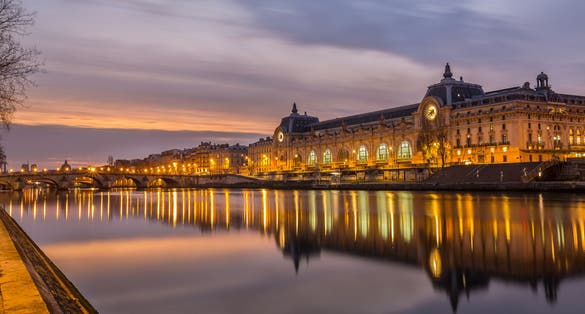 Photo of night view of the D'Orsay Museum and the Seine river, Paris, France.