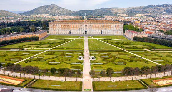 Aerial view of the Royal Palace of Caserta also known as Reggia di Caserta. It is a former royal residence with large gardens in Caserta, near Naples, Italy. It is the main facade of the building.