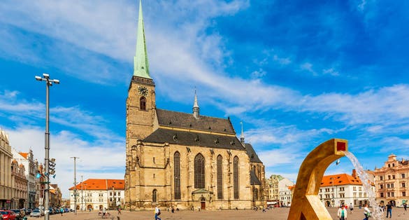 Photo of St. Bartholomew's Cathedral in the main square of Plzen with blue sky and clouds in sunny day, Czech Republic.
