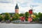 photo of panoramic cityscape from a sailing boat. Yacht marina, cathedral, traditional houses, windmill. Strängnäs, Mälaren lake, Sweden.