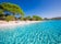 photo of sandy Santa Giulia beach with pine trees and azure clear water in Porto Vecchio, Corsica, France, Europe.