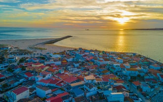 Photo of aerial view of Costa da Caparica coastline of glorious sandy beaches, powerful Atlantic waves, Portugal.