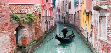 Famous buildings, gondolas and monuments by the Rialto Bridge of Venice on the Grand Canal, Italy.