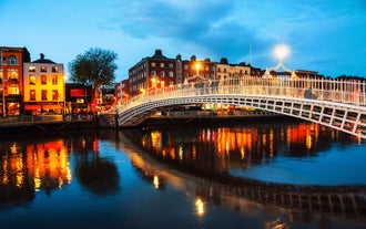 Aerial view of Dublin city center at sunset with River Liffey and Samuel Beckett bridge in the middle. Bridge designed by Santiago Calatrava.