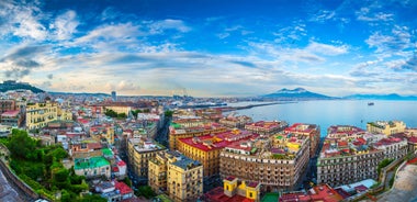 Naples, Italy. View of the Gulf of Naples from the Posillipo hill with Mount Vesuvius far in the background and some pine trees in foreground.