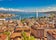 Geneva skyline cityscape, French-Swiss in Switzerland. Aerial view of Jet d'eau fountain, Lake Leman, bay and harbor from the bell tower of Saint-Pierre Cathedral. Sunny day blue sky.
