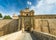 Photo of entrance bridge and gate to Mdina, a fortified medieval city in the Northern Region of Malta.