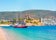 photo of panoramic view of Saint Peter Castle (Bodrum castle) and marina view of Bodrum beach in the foreground in Bodrum, Turkey.