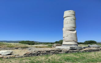Photo of aerial view of Pythagorio port with colourful houses and blue sea, Samos island, Greece.