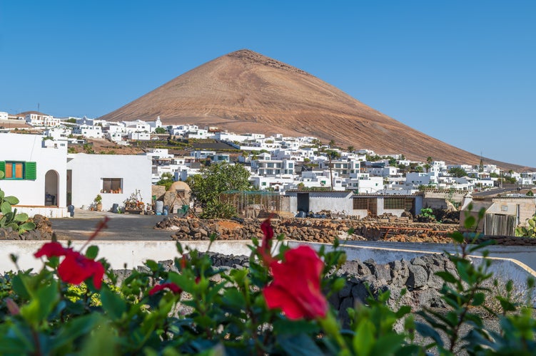 Charming view of Tias village against the iconic Montaña Blanca in Lanzarote, capturing the essence of Canarian life and volcanic landscapes.