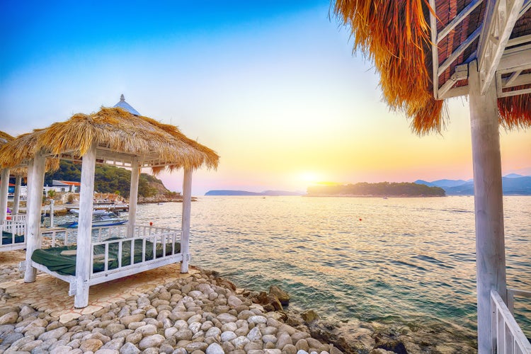 Photo of Thatched canopies and awnings on the beach Copacabana at sunset in Dubrovnik.