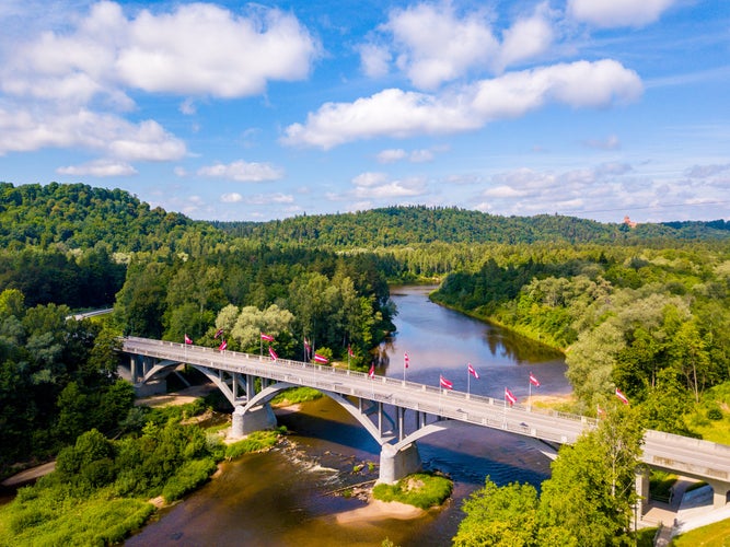 Aerial view of the Sigulda city with Gauja river and a bridge across it with cable car over the valley