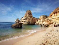 photo of an aerial view of wide sandy beach in touristic resorts of Quarteira and Vilamoura, Algarve, Portugal.