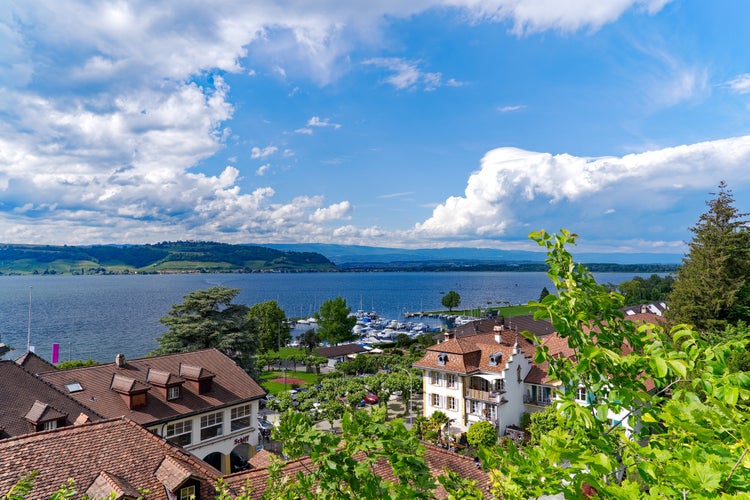 Photo of city of Murten on a sunny spring day with lake and mountain ,Switzerland.