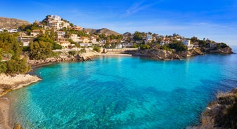 Photo of aerial panoramic view coastline and La Vila Joiosa Villajoyosa touristic resort townscape, sandy beach and Mediterranean seascape, Costa Blanca, Spain.