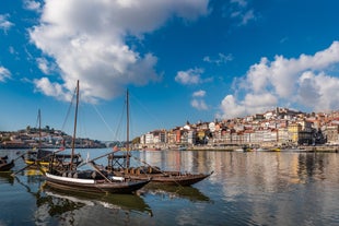 Porto, Portugal old town ribeira aerial promenade view with colorful houses, Douro river and boats.