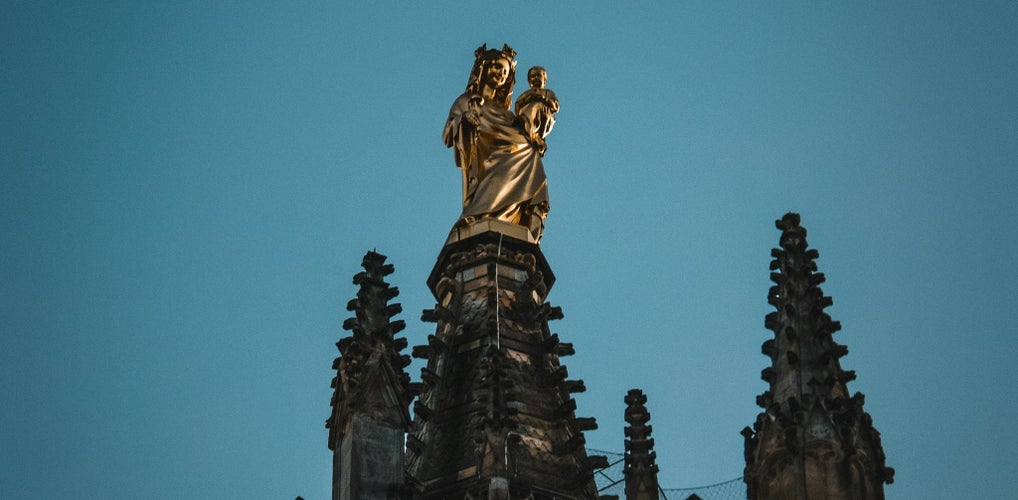 Golden Virgin Mary statue atop Tour Pey Berland (Pey Berland Tower) in Bordeaux at dusk..jpg