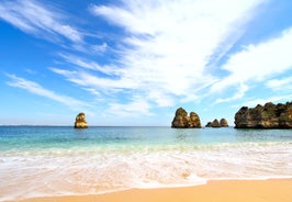 Photo of wide sandy beach in white city of Albufeira, Algarve, Portugal.