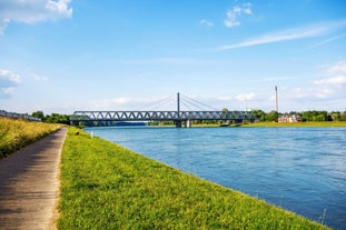 Photo of scenic summer view of the German traditional medieval half-timbered Old Town architecture and bridge over Pegnitz river in Nuremberg, Germany.