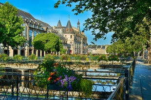 Photo of Vannes, beautiful city in Brittany, boats in the harbor, with typical houses and the cathedral in background, France.