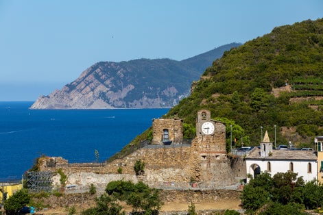 photo of view of Landscape panorama with castle of Riomaggiore, historic building located in the upper part of the historic center of Riomaggiore, in the Cinque Terre, in the province of La Spezia.,Riomaggiore italy.