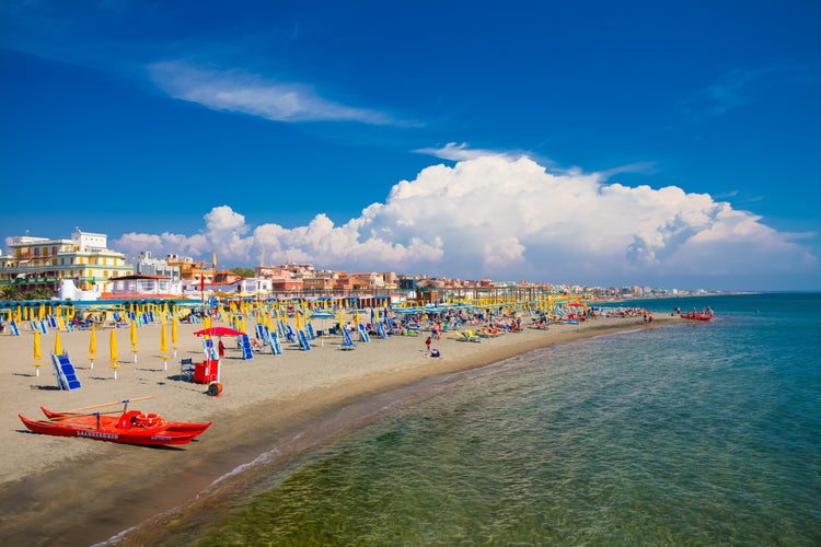 Swimming and relaxing people on the beautiful beach Lido di Ostia ( Lido di Roma), private beach Battistini, Italy.