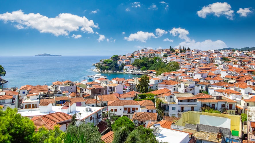 Photo of Skiathos town, beautiful view of the old town with boats in the harbor.