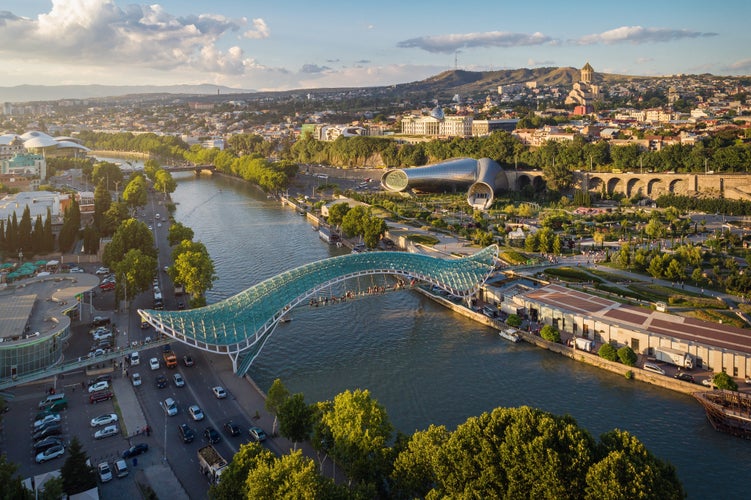 photo of Panoramic aerial view of downtown Tbilisi, Georgia. In the foreground is the Peace Bridge over the Mtkvari River.