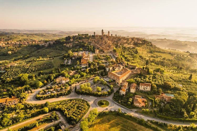 photo of view of Aerial view of famous medieval San Gimignano hill town with its skyline of medieval towers, including the stone Torre Grossa. Province of Siena, Tuscany, Italy.