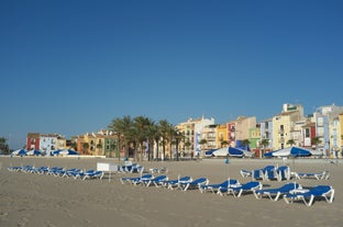 Photo of aerial panoramic view coastline and La Vila Joiosa Villajoyosa touristic resort townscape, sandy beach and Mediterranean seascape, Costa Blanca, Spain.