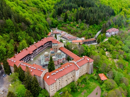 Photo of beautiful aerial view of the vibrant decoration of the Orthodox Rila Monastery, a famous tourist attraction and cultural heritage monument in the Rila Nature Park mountains in Bulgaria.
