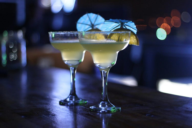 Two Margarita Glasses on Brown Wooden Surface.jpg