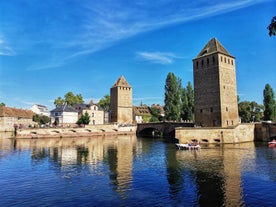 Photo of traditional half-timbered houses on picturesque canals in La Petite France in the medieval fairytale town of Strasbourg, France.