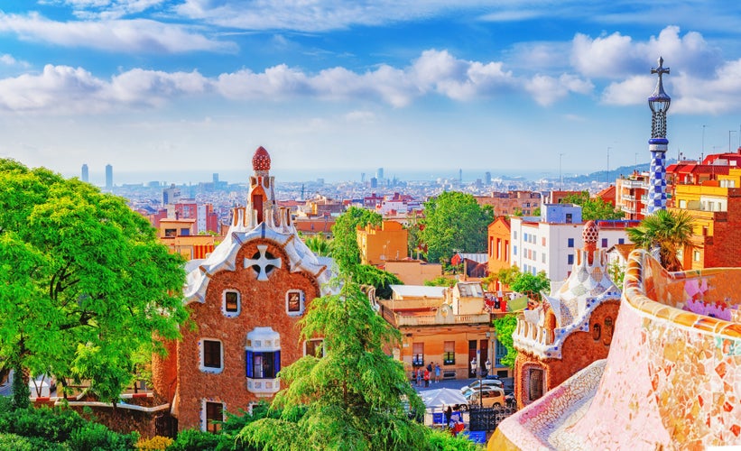 Photo of fantastic view on Barcelona city over Park Guell, famous and popular landmark and travel destination in Europe.