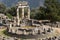 photo of view of Tholos at the sanctuary of Athena Pronaia, Delphi, Greece.