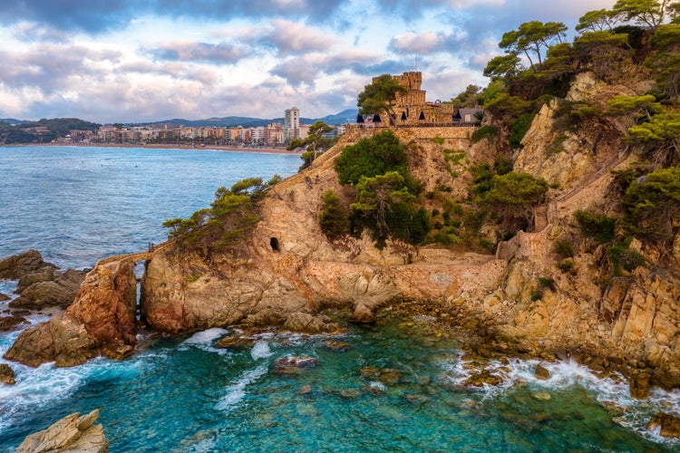 Colorful rocks on the Costa Brava coast in Lloret de Mar, a popular tourist resort on Mediterranean sea coast, Catalonia, Spain.