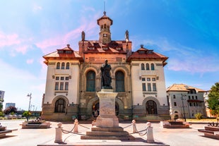 Photo of Water fountain in central square in Iasi town, Cultural Palace in background, Moldavia, Romania.