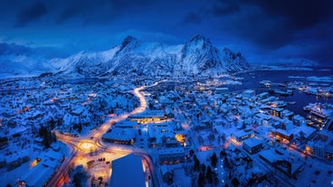 Photo of houses, bridge and panorama of Norwegian city Tromso beyond the Arctic circle from mountain in Norwegian fjords.