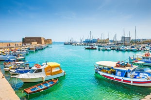 Photo of aerial view of Chania with the amazing lighthouse, mosque, venetian shipyards, Crete, Greece.