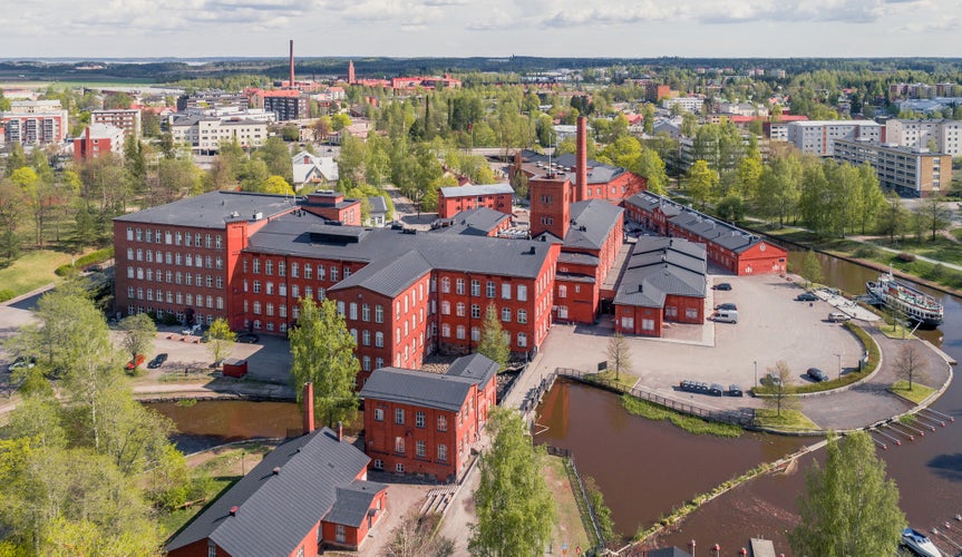 Photo of aerial view of red brick buildings of former cotton spinning mill in Forssa, Finland.