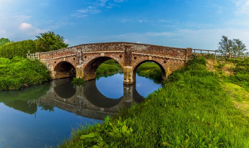 Photo of Reflections of the old bridge at Bodiam, Sussex in the river Rother,England.