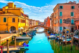 Famous buildings, gondolas and monuments by the Rialto Bridge of Venice on the Grand Canal, Italy.