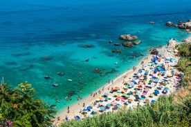 photo of an aerial view of Parghelia in Italy. Overview of seabed seen from above, transparent water and beach with umbrellas.