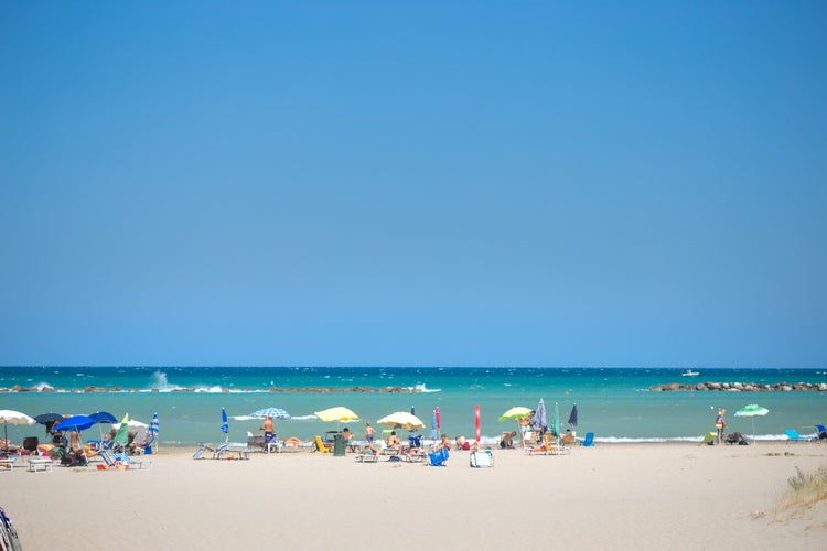 white beaches italy. sea sky people umbrellas sun beds