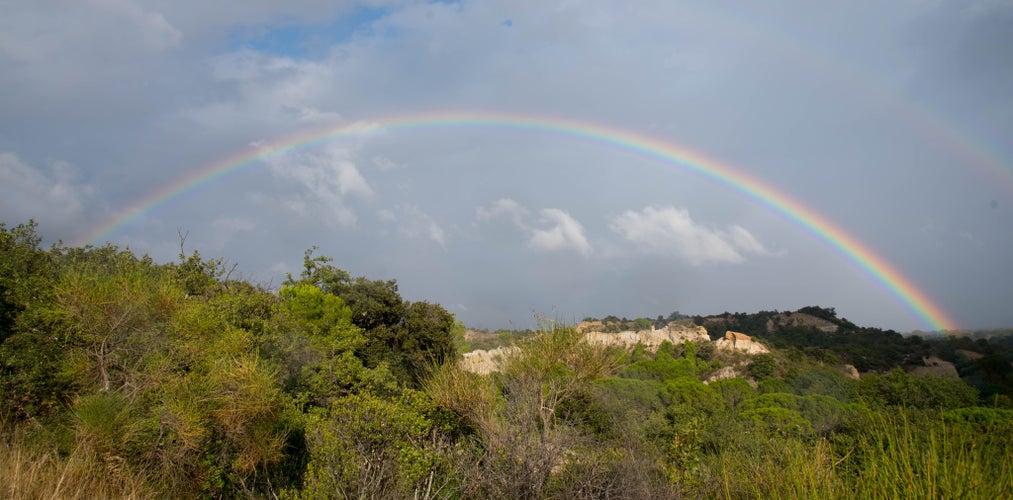 Photo of Rainbow above the rocks of Ill sur Tet in France.