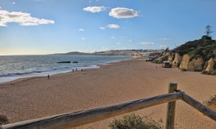 photo of an aerial view of wide sandy beach in touristic resorts of Quarteira and Vilamoura, Algarve, Portugal.