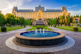 Photo of Water fountain in central square in Iasi town, Cultural Palace in background, Moldavia, Romania.